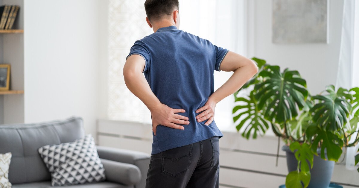 Person experiencing back pain, possibly sciatica.Title: Sciatica Back Pain Relief